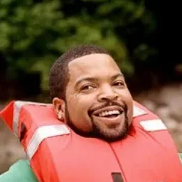 Ice Cube looking happy with a red life preserver around his neck